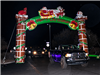 Cars Driving Through Inflatable green and red Merry Christmas Arch Way