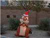 Brown inflatable chipmunk wearing a santa hat and holding an acorn