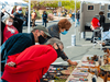 Three customers look interested in booth