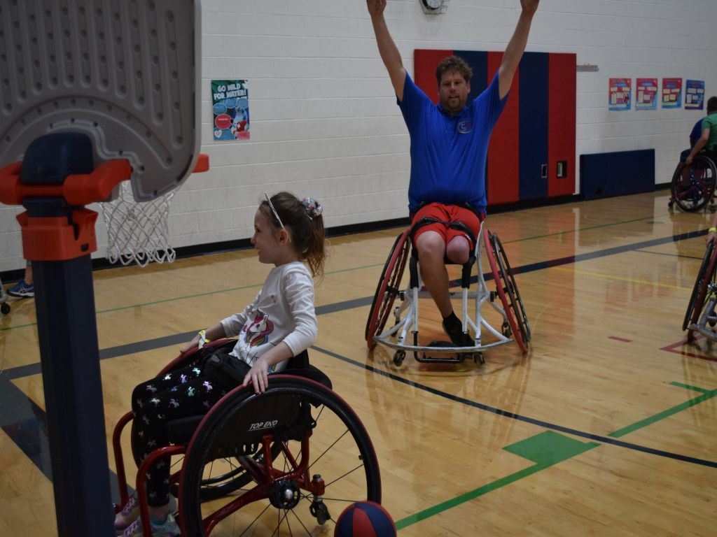 Coach Celebrating Girl Making Basket